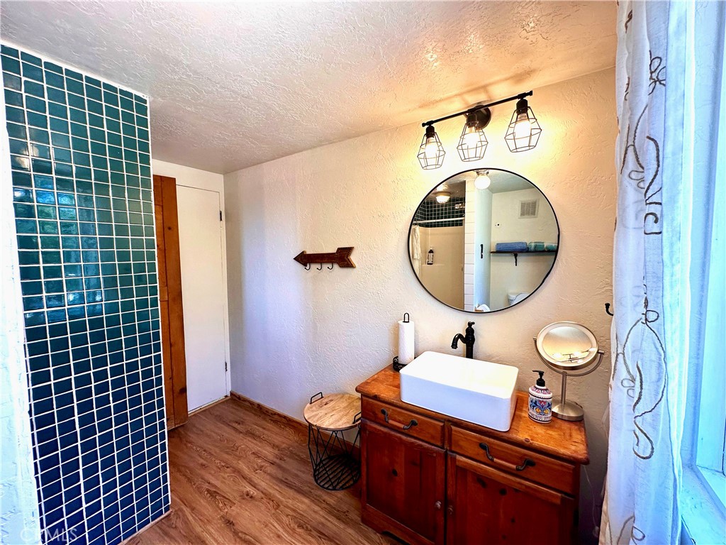 24387 Rocky Point Road Idyllwild, CA 92549 - Photo 7 of 29 a bathroom with a sink mirror vanity and toilet
