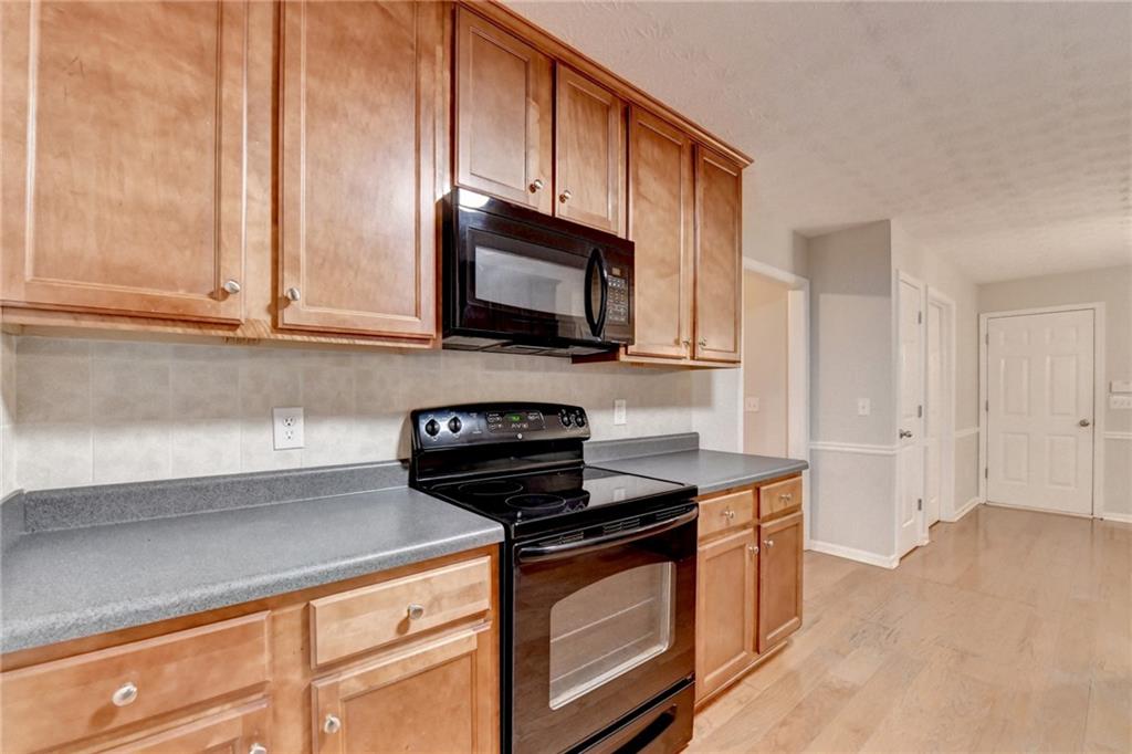 310 Andrew Ridge Drive Jefferson, GA 30549 - Photo 17 of 52 a kitchen with stainless steel appliances a stove a microwave a sink and cabinets