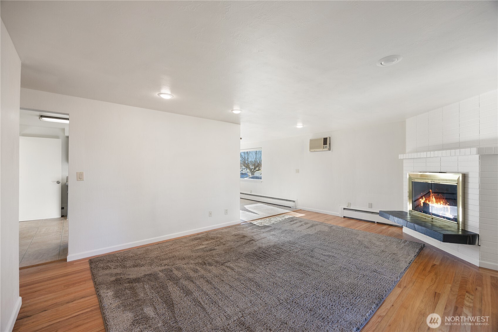 110 Linden Avenue Moses Lake, WA 98837 - Photo 17 of 40 wooden floor in an empty room with a fireplace