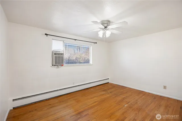 a bathroom with a granite countertop sink mirror vanity and toilet