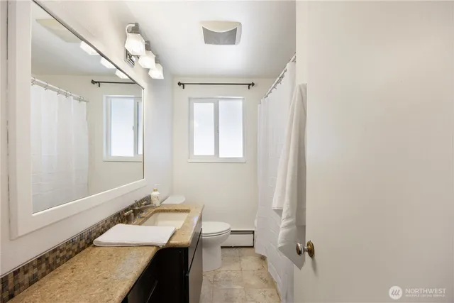 an empty room with a ceiling fan and window