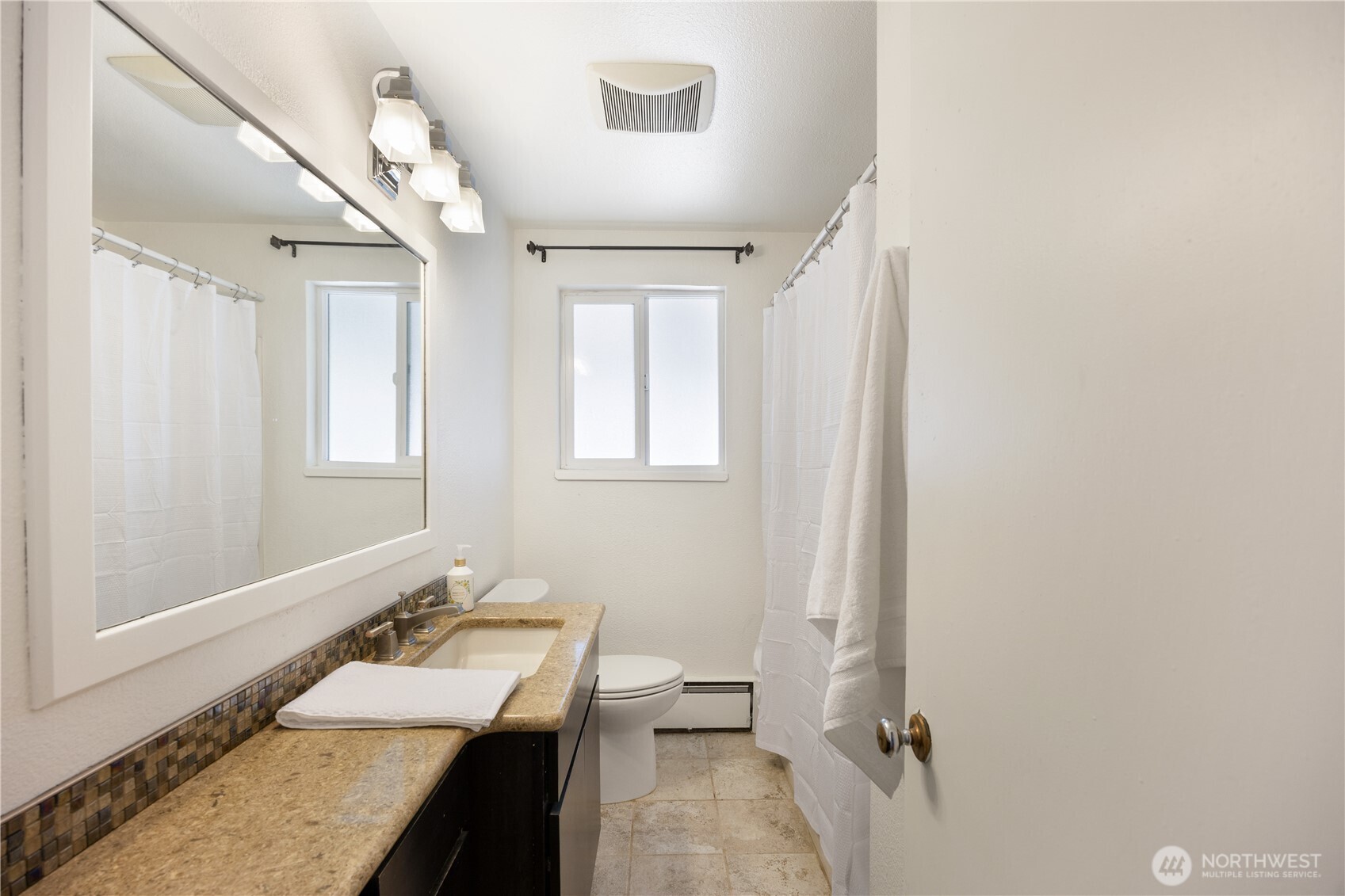 110 Linden Avenue Moses Lake, WA 98837 - Photo 23 of 40 a bathroom with a granite countertop sink mirror vanity and toilet