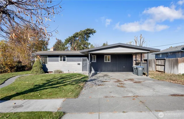 a front view of a house with a garden and yard