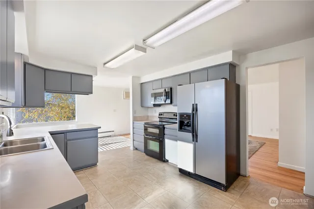 a kitchen with a sink stove and refrigerator