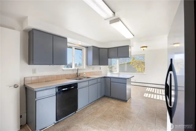 a kitchen with stainless steel appliances kitchen island granite countertop a refrigerator and a stove top oven