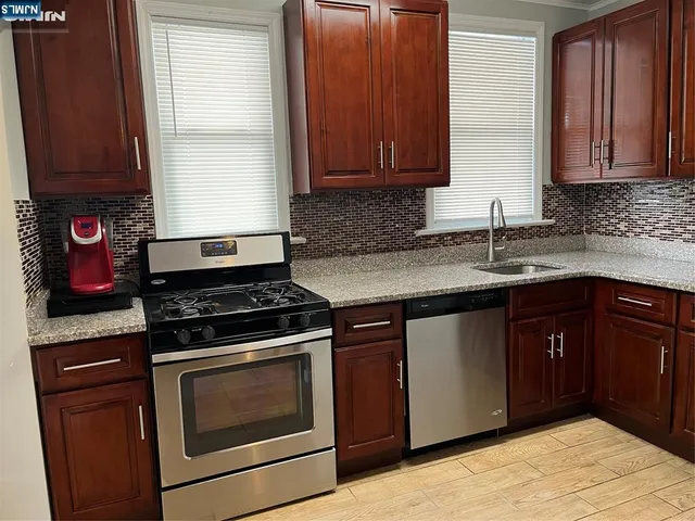 a kitchen with a sink and a refrigerator