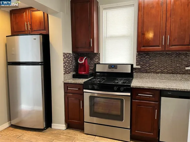 a view of walk in closet with wooden floor