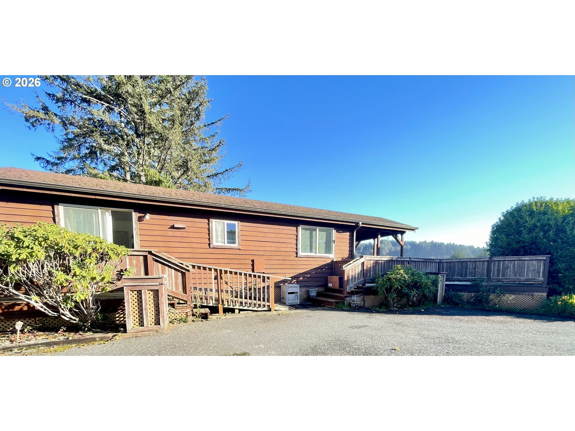 19921 Whaleshead Road, Unit T5 Brookings, OR 97415 - Photo 29 of 34 a front view of a house with a yard and potted plants