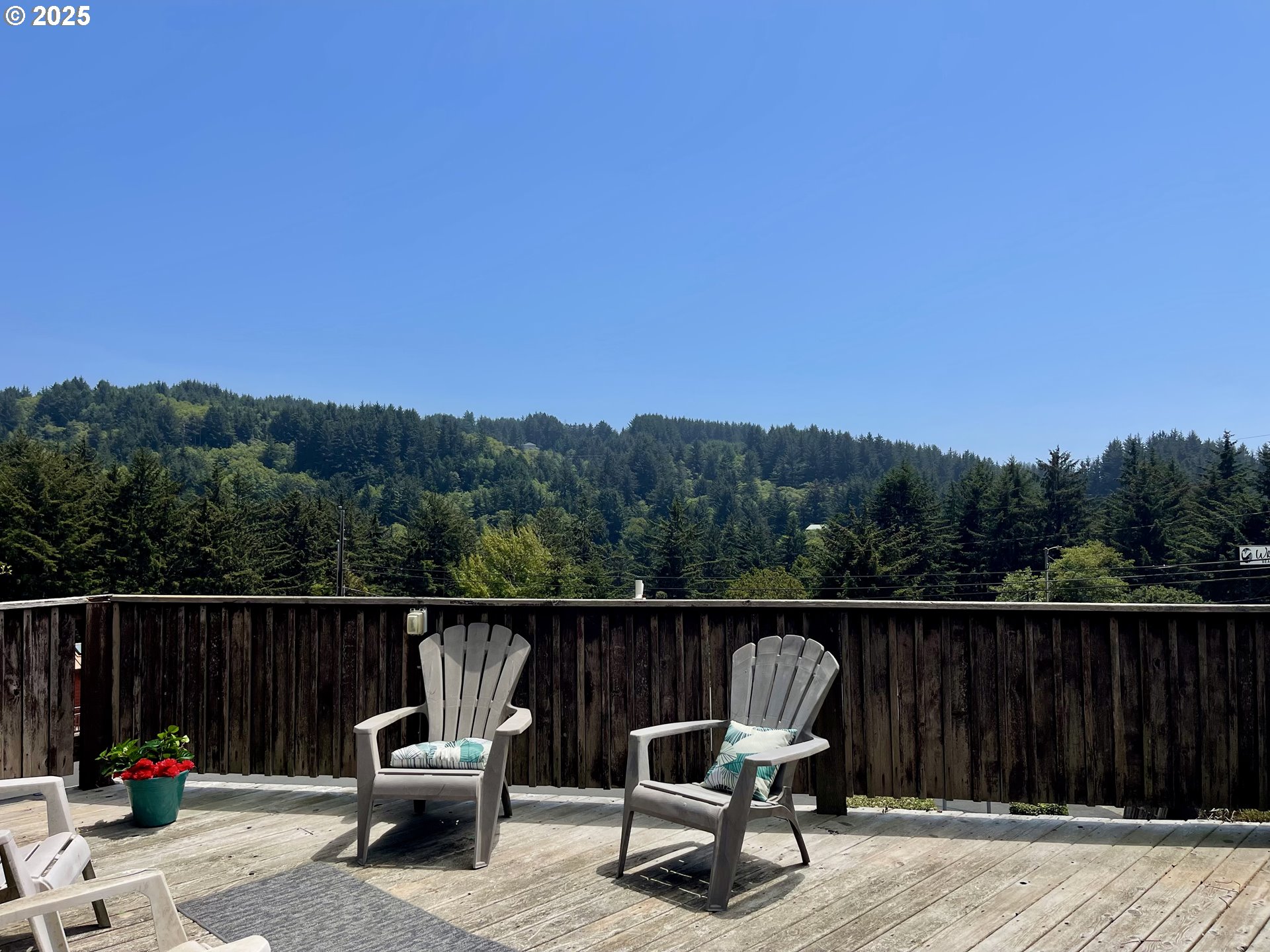 19921 Whaleshead Road, Unit T5 Brookings, OR 97415 - Photo 3 of 34 a view of chair and trees in the background