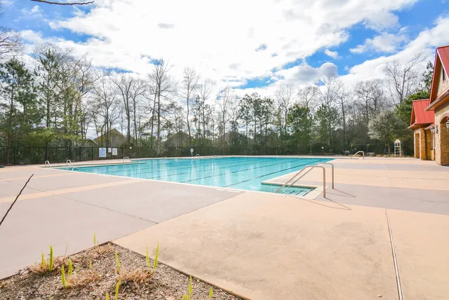 a view of a swimming pool with a yard