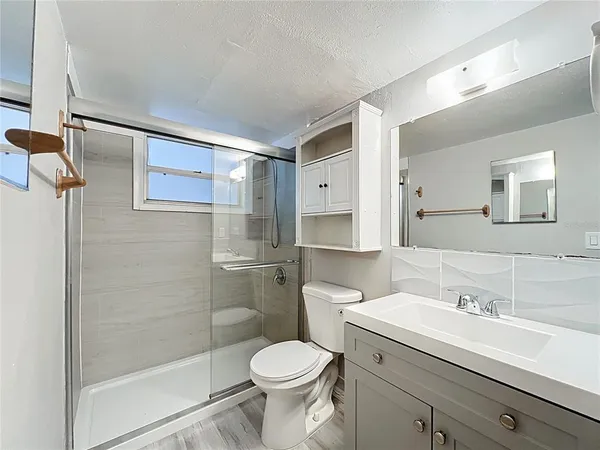 a bathroom with a sink toilet and shower