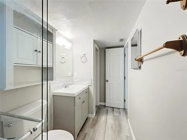 a bathroom with a sink a toilet and shower