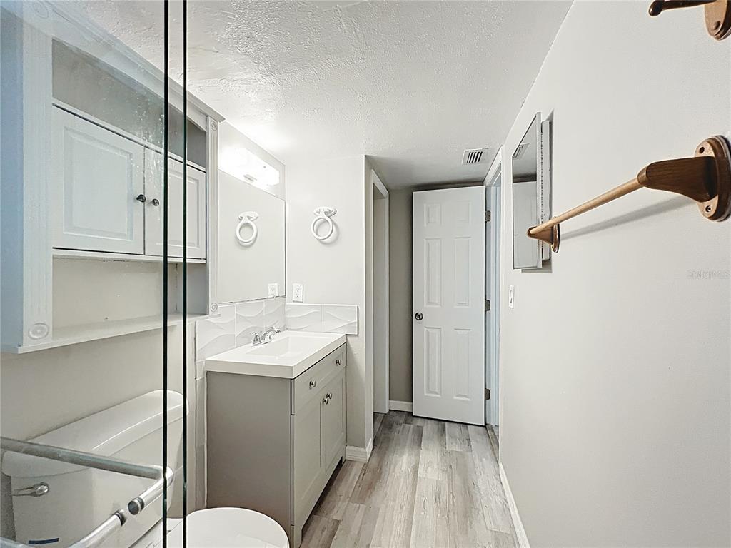11705 3rd Street East, Unit 4 Treasure Island, FL 33706 - Photo 12 of 23 a bathroom with a sink a toilet and shower