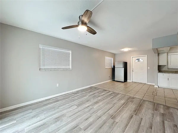 a view of empty room with wooden floor