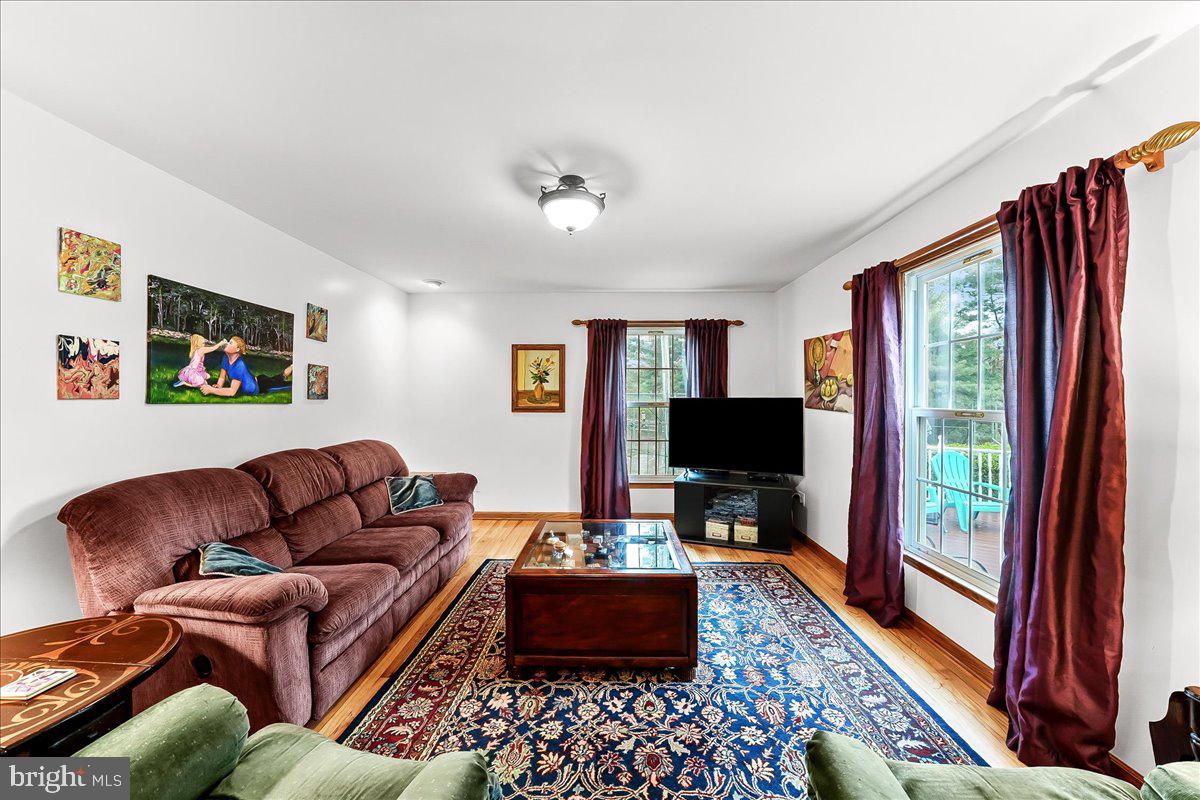 701 Pheasant Run Kennett Square, PA 19348 - Photo 12 of 41 a living room with furniture and a flat screen tv