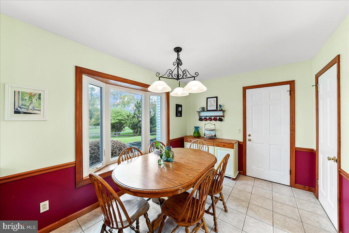 701 Pheasant Run Kennett Square, PA 19348 - Photo 14 of 41 a dining room with furniture a chandelier and window