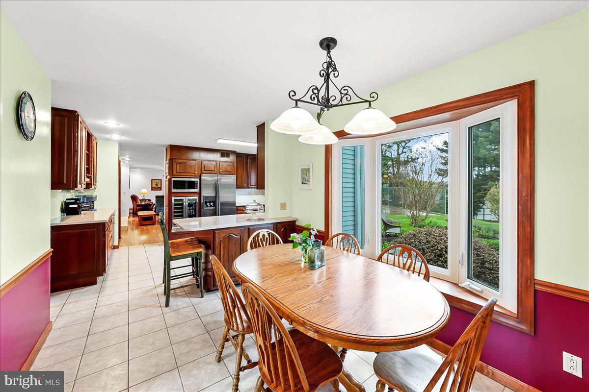 701 Pheasant Run Kennett Square, PA 19348 - Photo 15 of 41 a dining room with furniture a chandelier and window