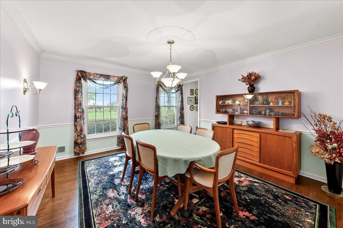 701 Pheasant Run Kennett Square, PA 19348 - Photo 17 of 41 a dining room with furniture a chandelier and wooden floor