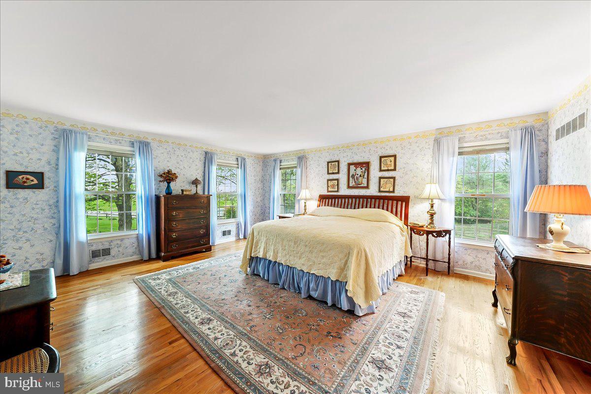 701 Pheasant Run Kennett Square, PA 19348 - Photo 22 of 41 a spacious bedroom with a bed a dresser and wooden floor