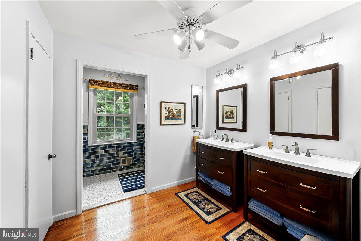 701 Pheasant Run Kennett Square, PA 19348 - Photo 23 of 41 a spacious bathroom with a double vanity sink a large mirror and a shower