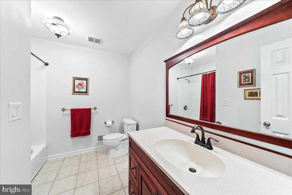 701 Pheasant Run Kennett Square, PA 19348 - Photo 28 of 41 a bathroom with a sink a toilet and a mirror