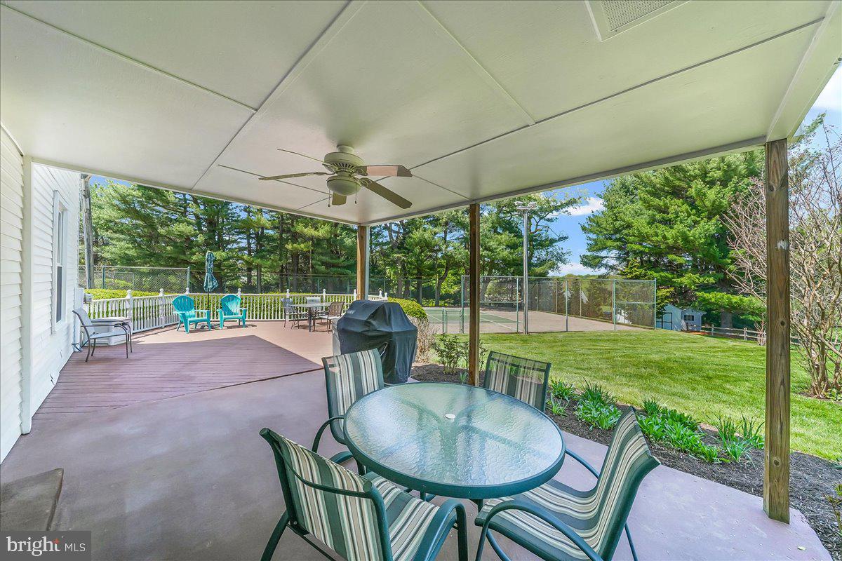 701 Pheasant Run Kennett Square, PA 19348 - Photo 35 of 41 a view of a patio with a table chairs and a small yard