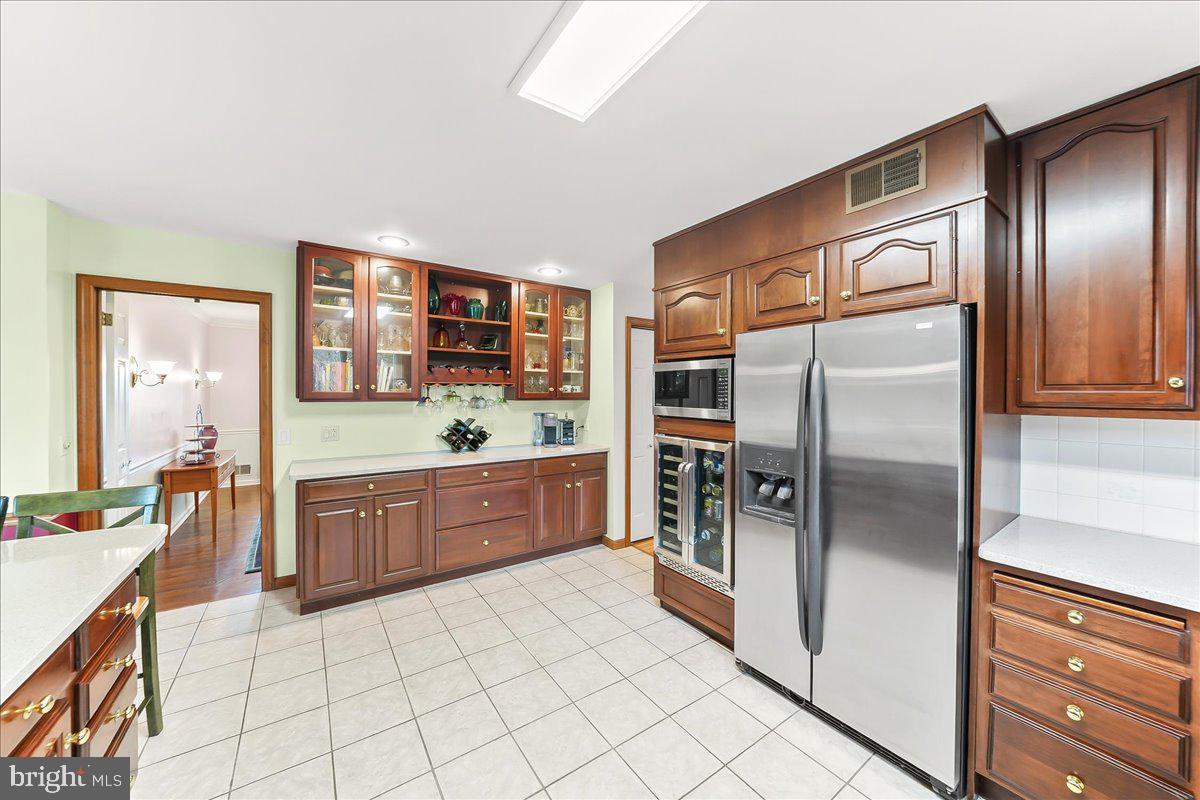 701 Pheasant Run Kennett Square, PA 19348 - Photo 7 of 41 a kitchen with stainless steel appliances a refrigerator and a stove