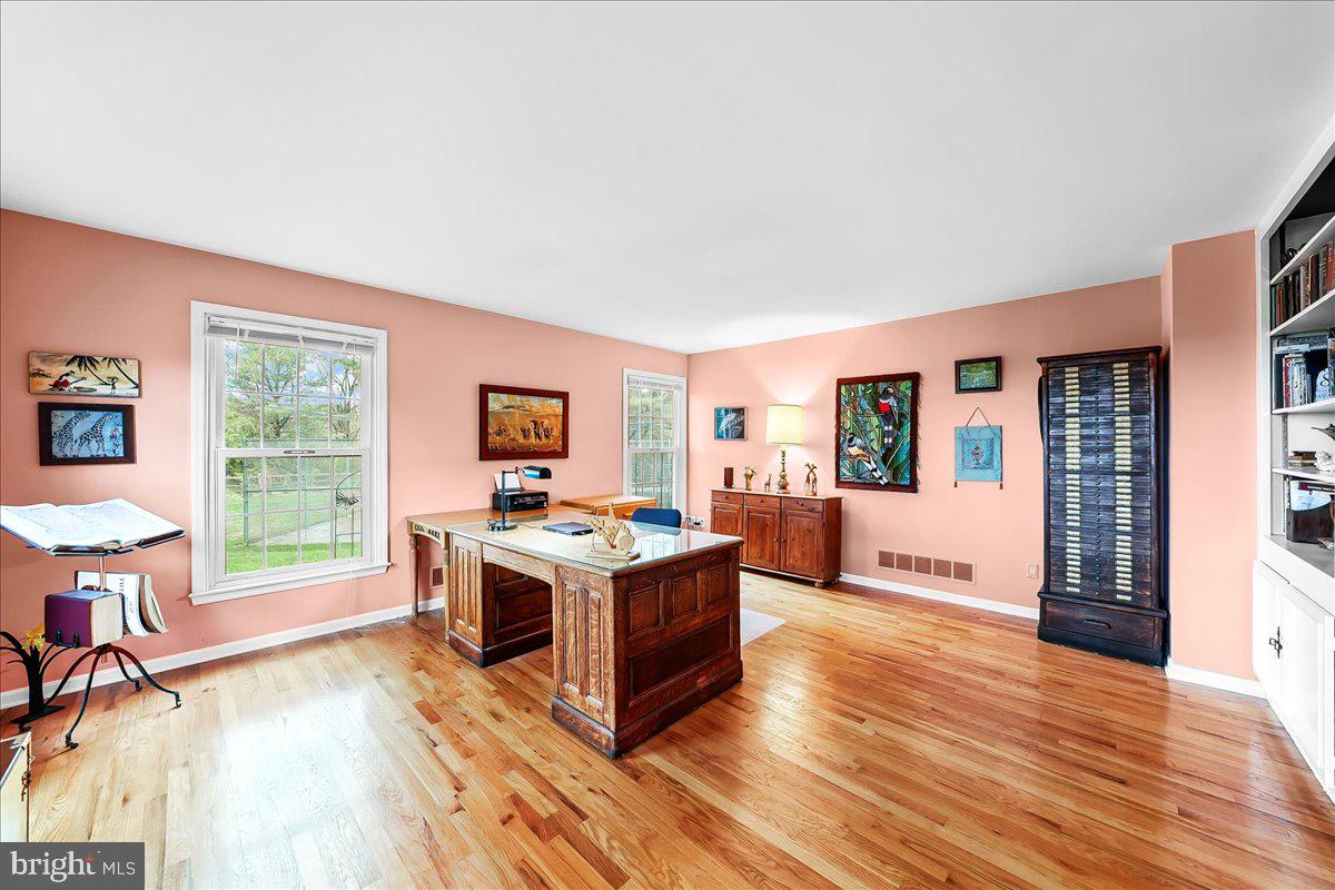 701 Pheasant Run Kennett Square, PA 19348 - Photo 8 of 41 a kitchen with a stove wooden floor wooden floor and a large window
