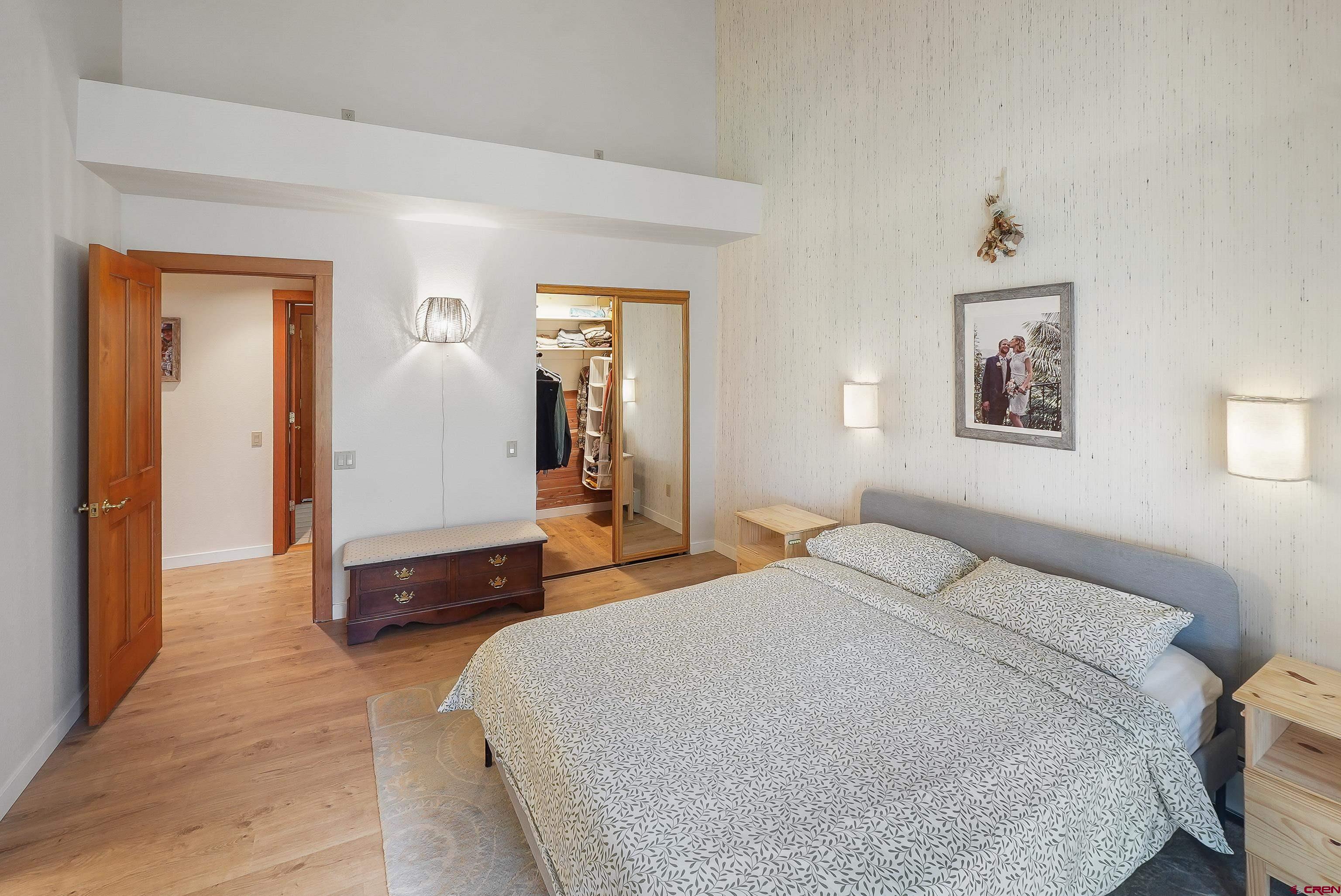 528 Cottonwood Creek Road Durango, CO 81301 - Photo 18 of 39 a bedroom with a bed and a chandelier