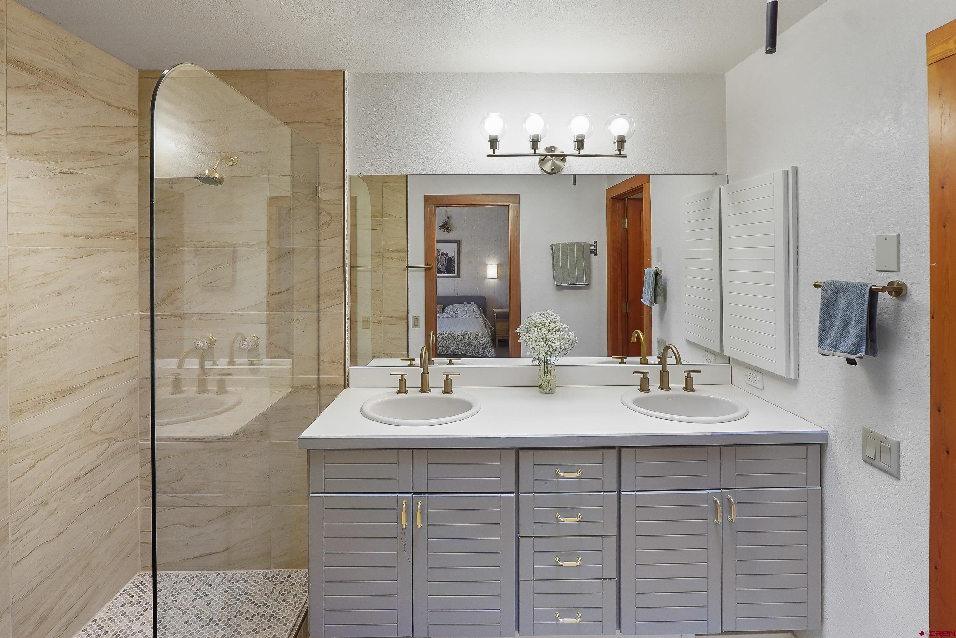 528 Cottonwood Creek Road Durango, CO 81301 - Photo 20 of 39 a bathroom with a double vanity sink and a mirror