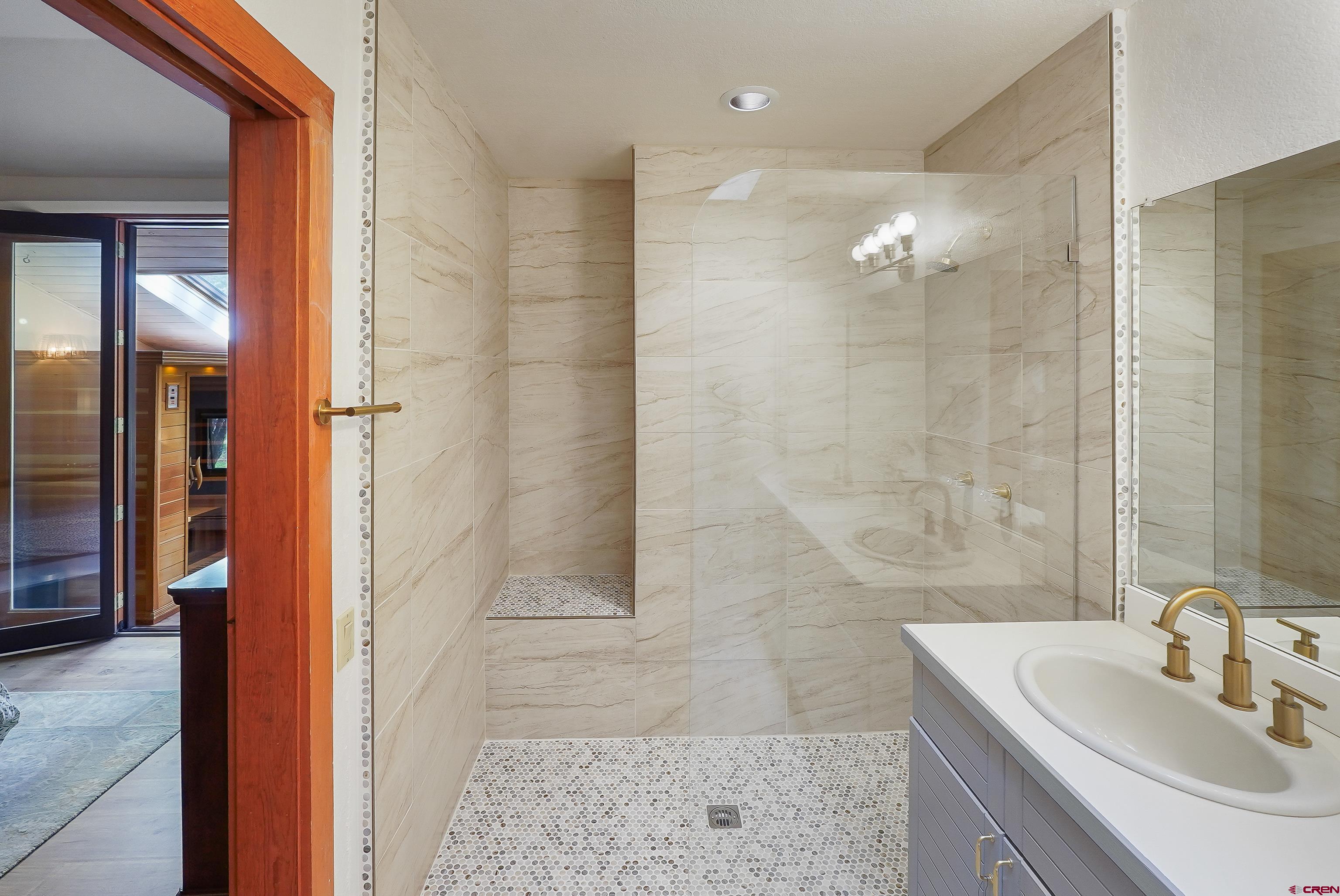 528 Cottonwood Creek Road Durango, CO 81301 - Photo 21 of 39 a bathroom with a sink a shower and a mirror