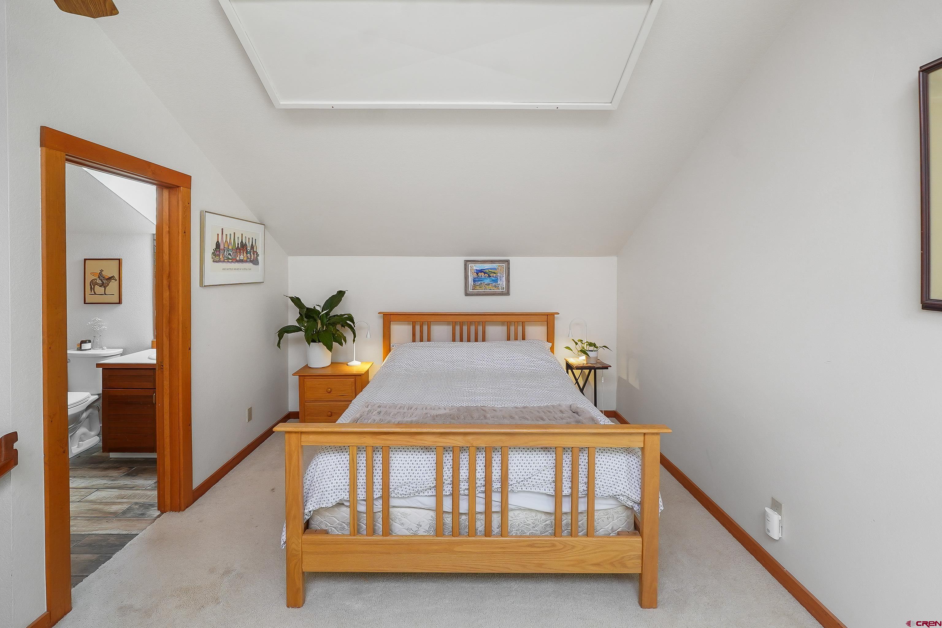 528 Cottonwood Creek Road Durango, CO 81301 - Photo 25 of 39 a bedroom with a bed and wooden floor