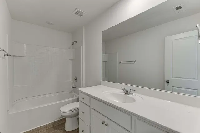 a bathroom with a sink a toilet and a bathtub