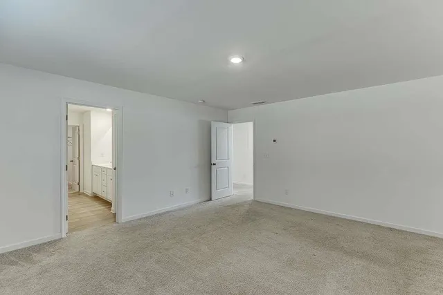 a spacious bathroom with a double vanity sink and a mirror