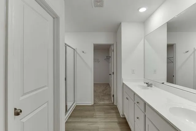 a bathroom with a glass shower door