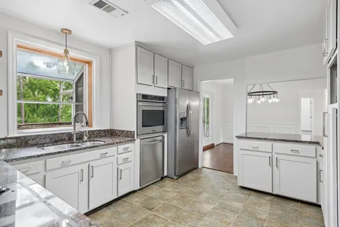 a kitchen with a sink stove and refrigerator