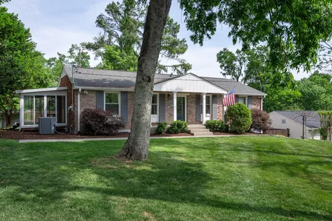 a front view of a house with a yard and porch
