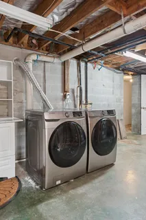 a utility room with sink dryer and washer
