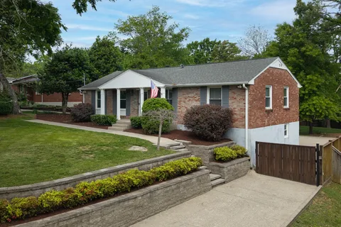 a front view of a house with a garden
