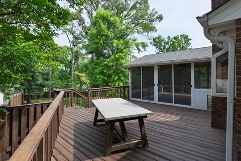a view of deck with table and chairs and wooden floor