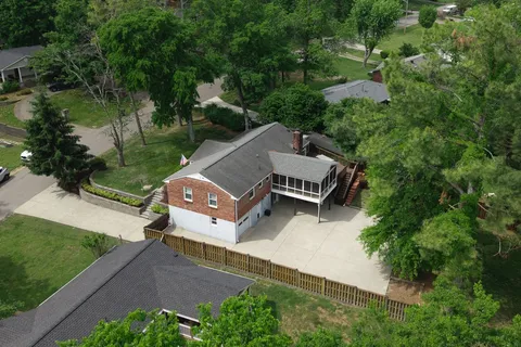 an aerial view of a house with garden space and street view
