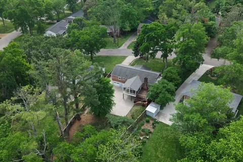 an aerial view of a house with yard and outdoor seating