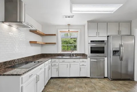 a kitchen with a sink stove and refrigerator