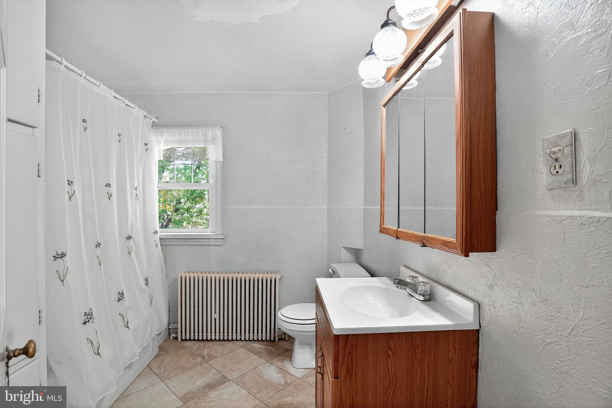 944 Galbraith Avenue Marcus Hook, PA 19061 - Photo 16 of 26 a bathroom with a sink toilet and shower