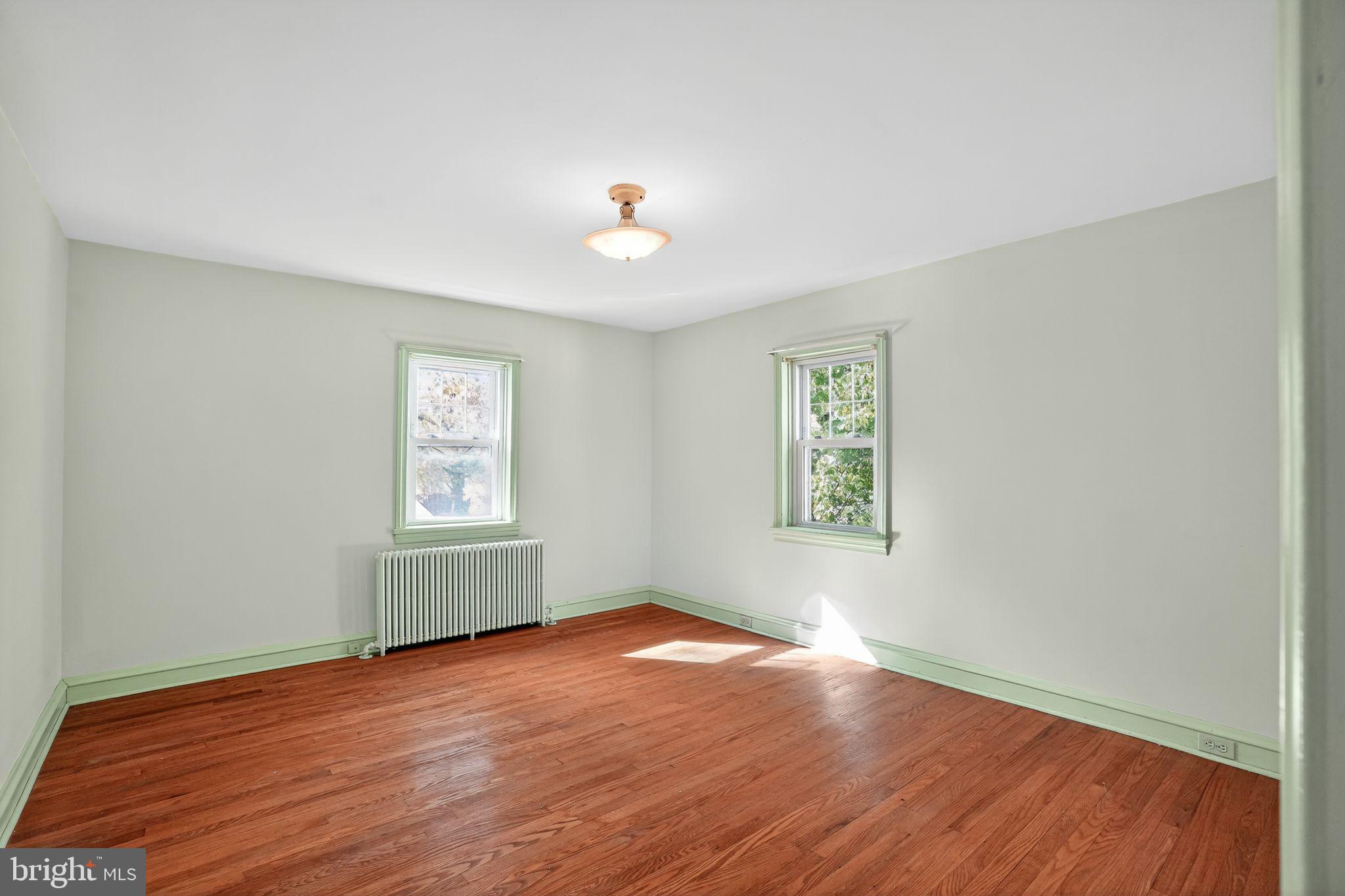 944 Galbraith Avenue Marcus Hook, PA 19061 - Photo 19 of 26 an empty room with wooden floor and windows