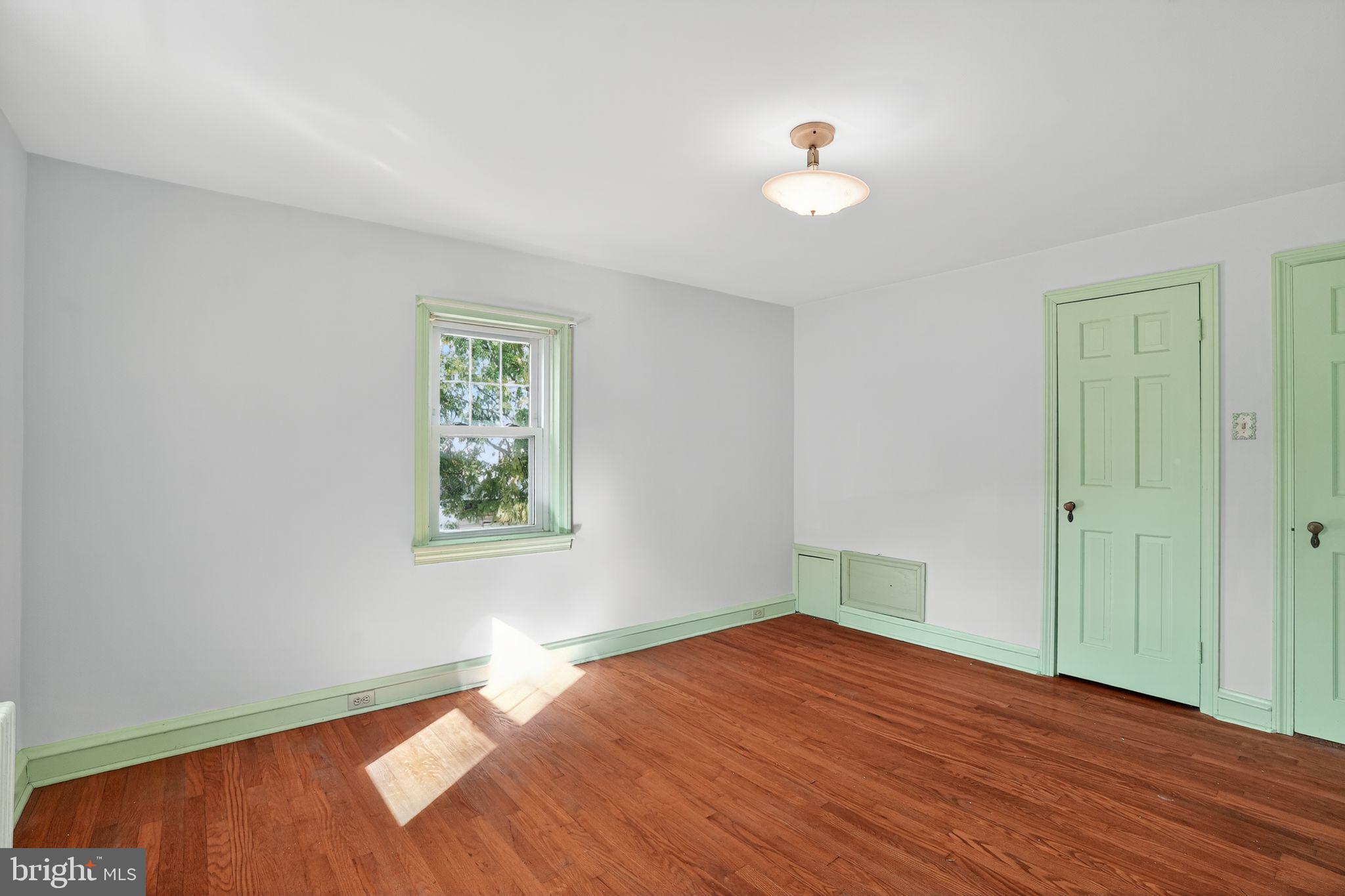 944 Galbraith Avenue Marcus Hook, PA 19061 - Photo 20 of 26 an empty room with wooden floor and windows