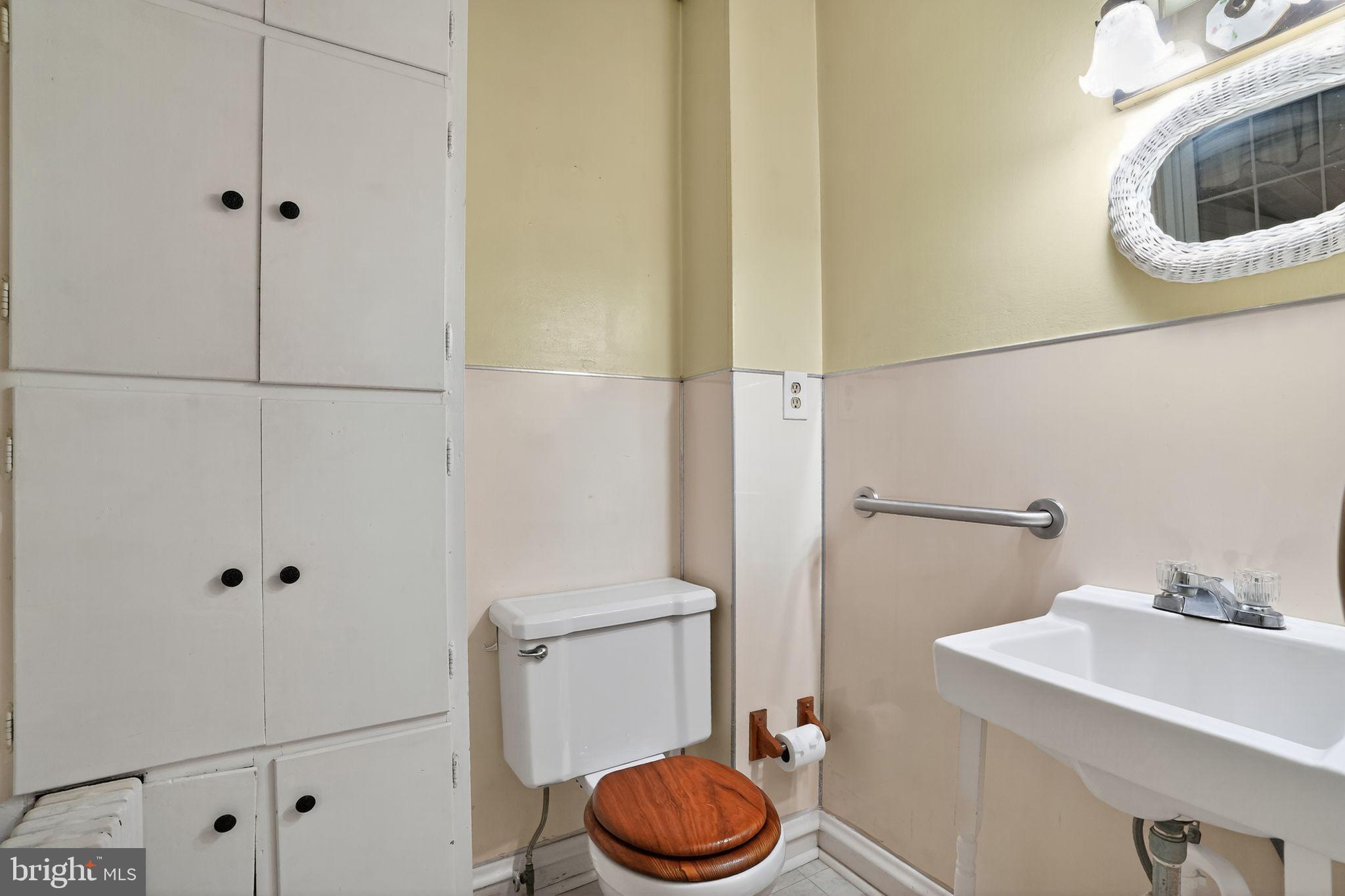 944 Galbraith Avenue Marcus Hook, PA 19061 - Photo 21 of 26 a bathroom with a sink a toilet and a mirror