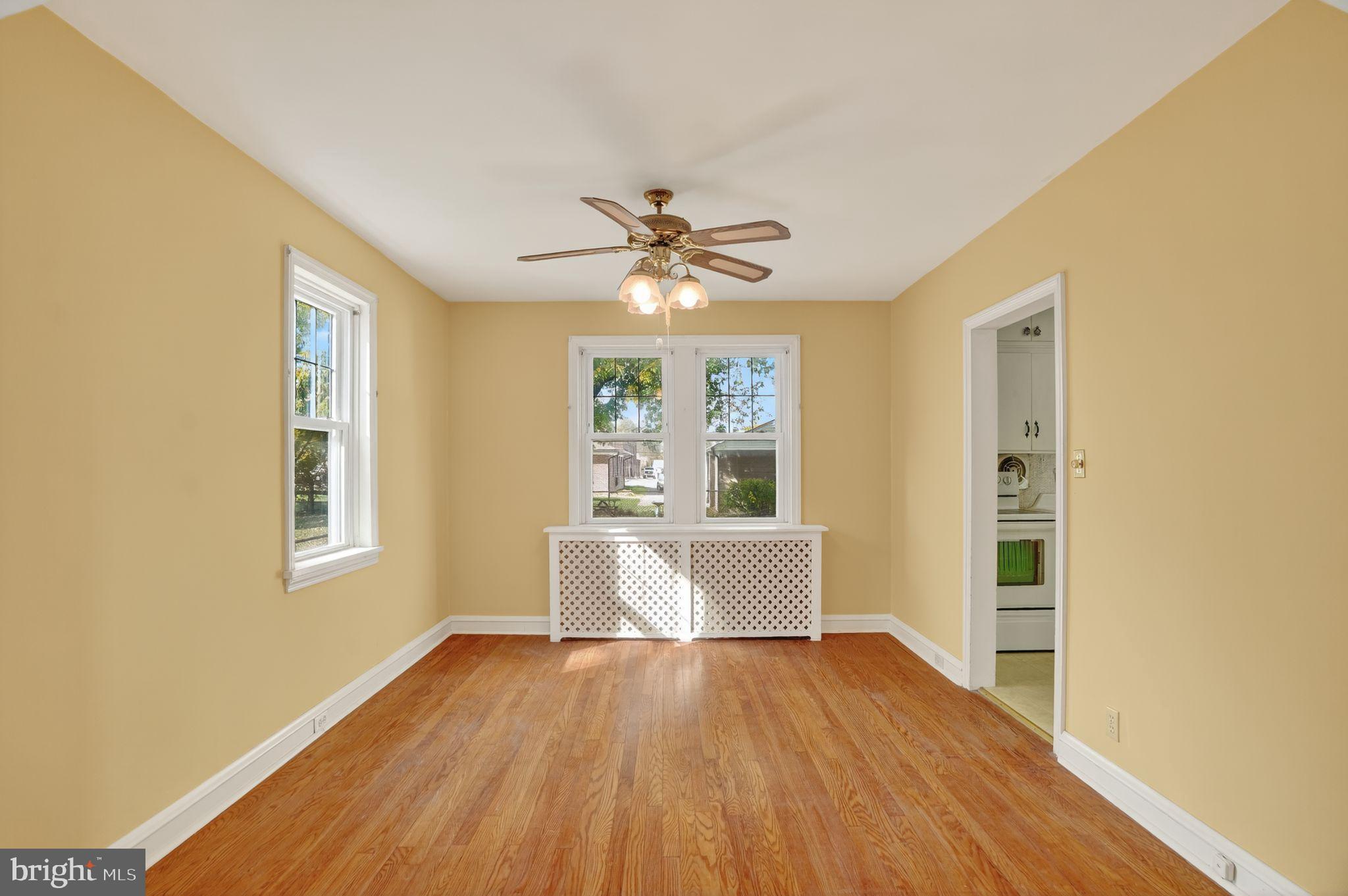 944 Galbraith Avenue Marcus Hook, PA 19061 - Photo 8 of 26 a view of an empty room with window and wooden floor