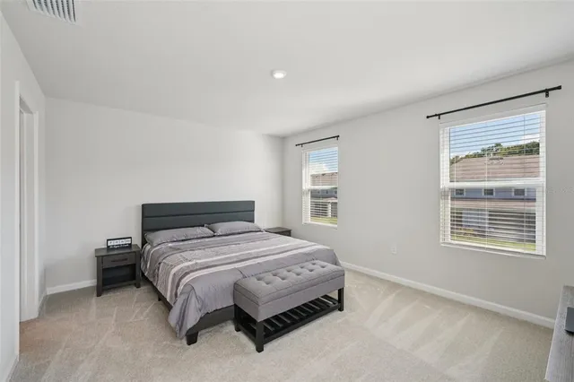 a bedroom with a bed lamp and window
