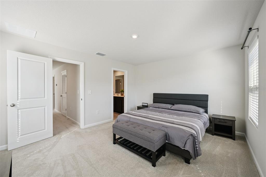 12057 Grizzly Lane New Port Richey, FL 34654 - Photo 13 of 25 a bedroom with a bed and a window